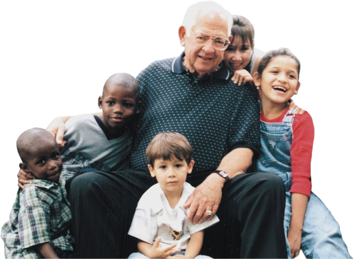 Dave Thomas and a group of kids smiling happily