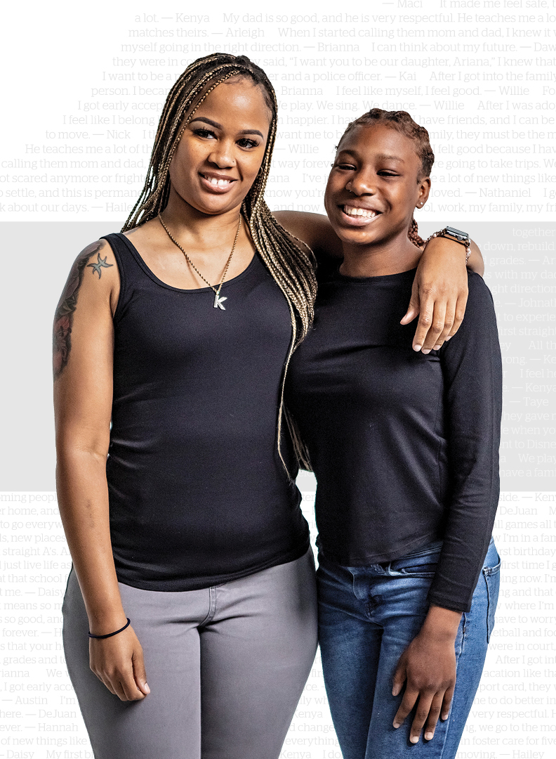 Mother with arm wrapped around daughter, smiling