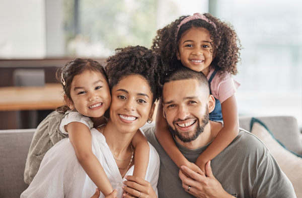 A family embracing and smiling.